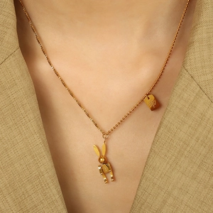 Mechanical gold rabbit pendant necklace with mixed box and bead chain worn by a model