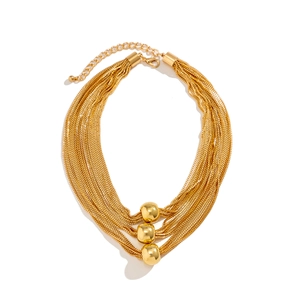Layered gold necklace featuring three polished metal ball pendants on multiple box chains