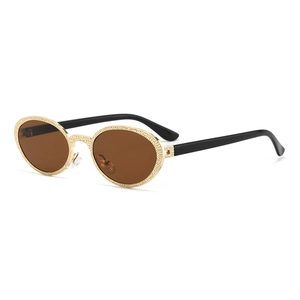 Vintage oval sunglasses with textured gold metal frames and brown lenses at a 45-degree angle