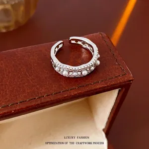Adjustable silver wave ring with white pearls and sparkling cubic zirconia stones