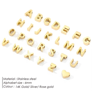 Detail view of 6mm stainless steel A-Z alphabet and heart charms in 14K gold finish