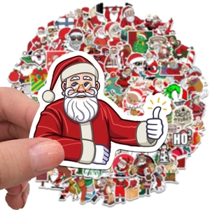 Close-up of colorful cartoon Santa Claus stickers with festive Ho Ho Ho typography