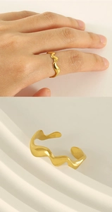 Detail showing the adjustable opening and irregular wave texture of the gold ring