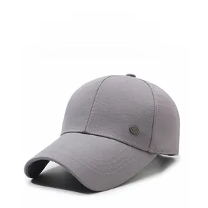 Detail of gray baseball cap featuring breathable textured fabric and a small metal logo