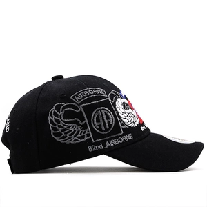 Detailed embroidery of 82nd Airborne Division insignia on black tactical baseball cap