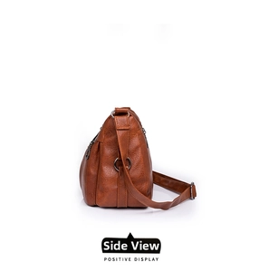 Side view of ginger yellow faux leather shoulder bag with multiple zippered compartments