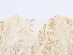 Detail view of champagne mesh fabric with intricate sequin floral embroidery and beads