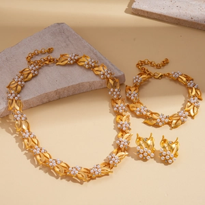 Detail view of vintage leaf jewelry set with gold finish pearls and zircon stones