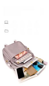 Detailed interior of a lavender waterproof school backpack showing multi-layer large capacity