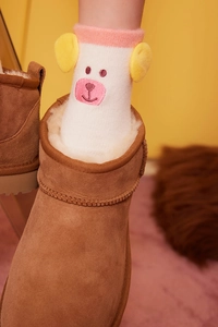 Close-up of fluffy white thermal socks featuring a cute pink bear face and 3D ears