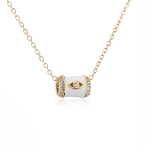 Detailed shot of white enamel cylinder pendant with golden evil eye and zircon accents