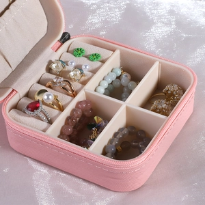 Pink portable travel jewelry box with cross-pattern leather and ring storage slots