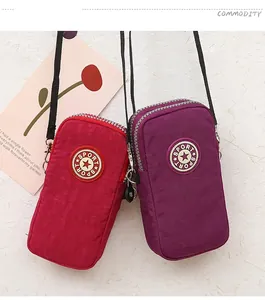 Vertical mini nylon crossbody phone bags in red and purple with multi-layer zippers