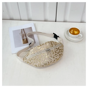 Flat lay of straw waist bag with leopard print, canvas strap and coffee on wood