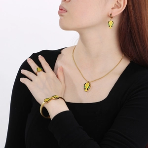Exaggerated golden jewelry set with hexagonal colorful enamel snake patterns on model