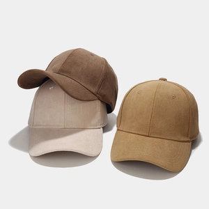 Three suede baseball caps in brown, beige, and camel colors with detailed stitching