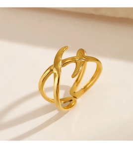 Close-up of 18K gold plated stainless steel ring with minimalist crossover design