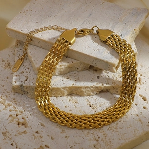 Detail of multi-strand woven chain bracelet in gold plated stainless steel