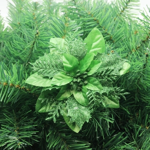 Detail of a green layered Christmas flower with glitter on festive pine branches