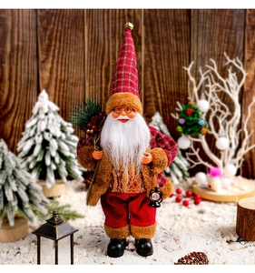 Standing Santa Claus doll holding gifts with gold sequins and plush texture details
