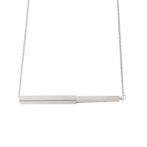 Macro shot of silver mirror-finish stainless steel bar pendant on a delicate chain