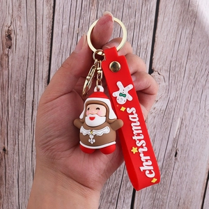 Detail of Christmas Santa PVC keychain with red silicone strap and gold metal clasp