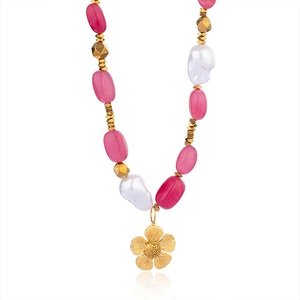 Baroque beaded necklace with pink stones, pearls and gold flower pendant on white background