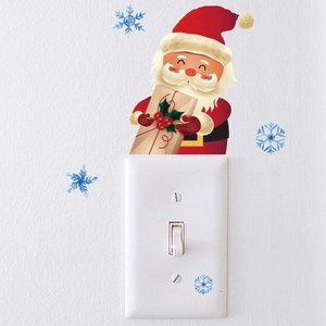 Glow-in-the-dark Santa and snowflake wall sticker applied above a light switch