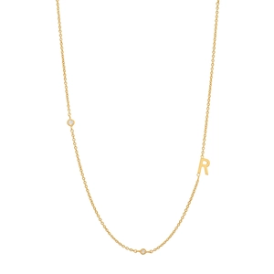 Detail of S925 silver gold necklace with letter R pendant and small diamond accents