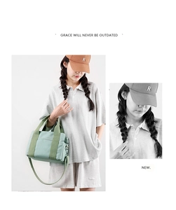 Detail of mint green canvas handbag with side pockets showing casual cross-body style