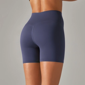 Detail view of navy blue high-waisted yoga shorts with seamless contouring and push-up effect