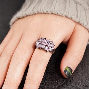 Detailed view of pink marquise-cut stones clustered on a black plated metal floral ring
