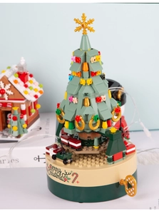 Macro detail of Christmas tree music box with Merry Christmas lettering on the base