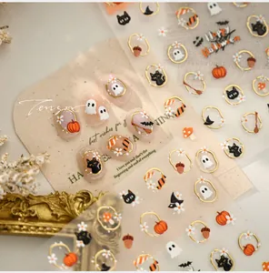 Detail of Halloween nail stickers with gold borders, cute pumpkin, ghost and black cat motifs