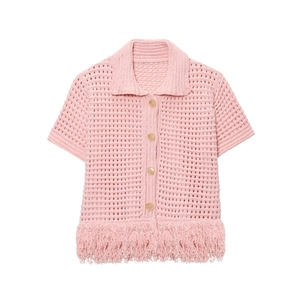 Detail of pink knit cardigan showing hollow crochet pattern and fringed hemline
