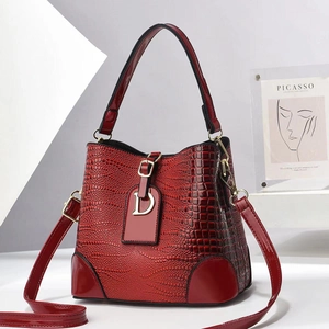Chic red crocodile pattern bucket bag with shiny patent finish and gold D-ring detail