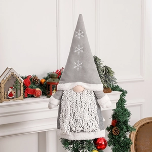 Grey Nordic Christmas gnome with snowflake knitted hat and white beard on a festive mantel