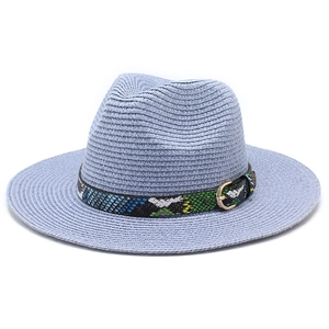 Detail of light blue straw jazz hat featuring colorful snake pattern band and gold buckle