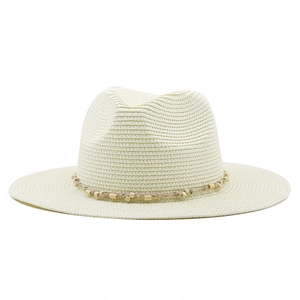 Close-up of woven straw hat with light brown cord and decorative wooden beads