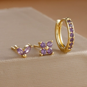 Macro shot of gold plated petal stud earrings set with purple zircon stones