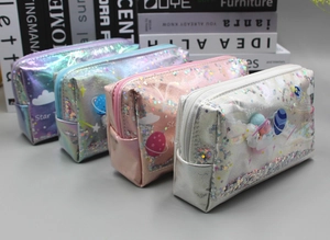 Detail of holographic Star Travel pencil cases in silver, pink, blue, and purple colors