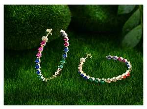 Close-up of 925 sterling silver stamp on multi-color teardrop gemstone gold hoop earrings