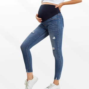 Close-up of elastic high-waist maternity belly support and distressed blue denim fabric