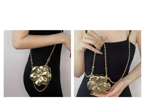 Detail of a gold metallic flower crossbody bag with bead chain strap in two styles