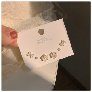 Detail view of the six-piece stud earring set featuring camellia flower and pearl designs