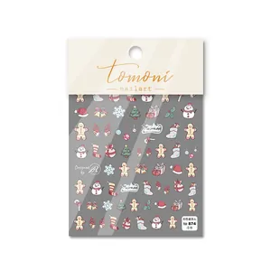 Detail of embossed Christmas nail stickers with pink gingerbread man and snowman designs