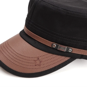 Detailed macro view of retro military cap with leather brim and five-pointed star embroidery