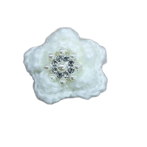 Elegant white crochet flower hair clip with pearls and rhinestones on a white background