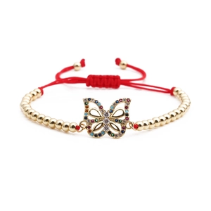 Gold-plated butterfly bracelet with multi-color zircon stones on a red woven rope band