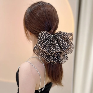 Elegant large leopard print mesh bow hair clip for women styled on low ponytail